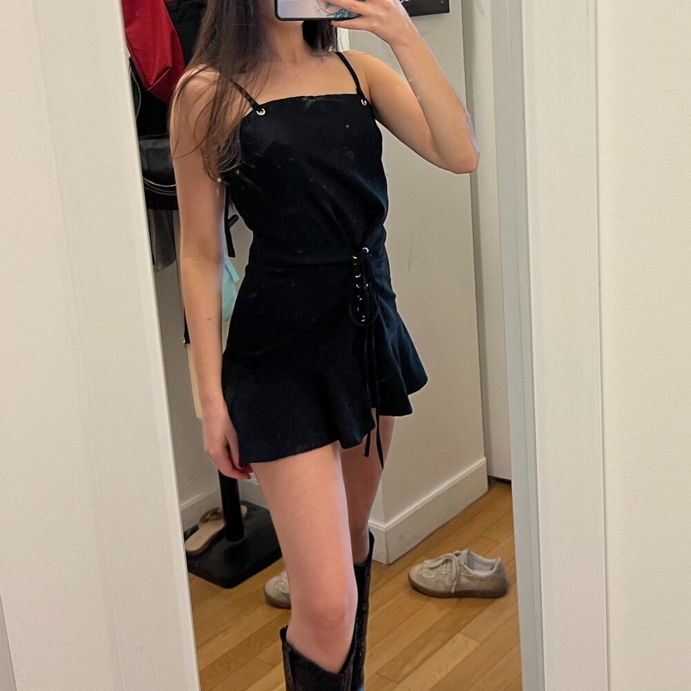 Adorable black romper with cute lace up detail. So flattering and trendy. Size S
